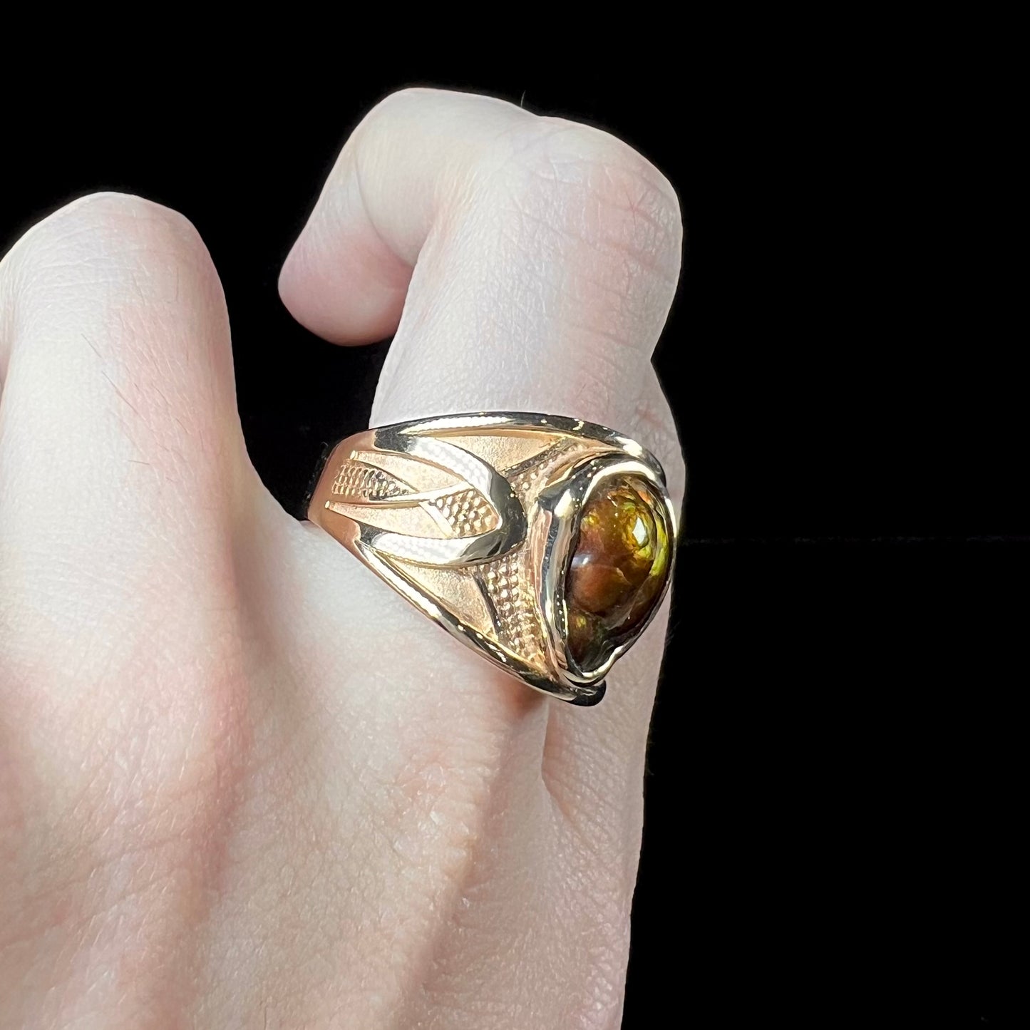 A men's 14kt yellow gold Mexican fire agate ring.