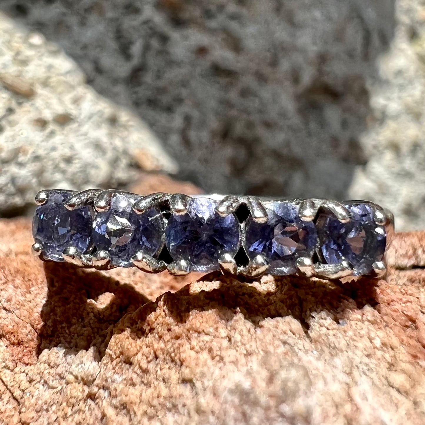 A sterling silver stackable ring set with five Standard Round Brilliant Cut tanzanite stones.