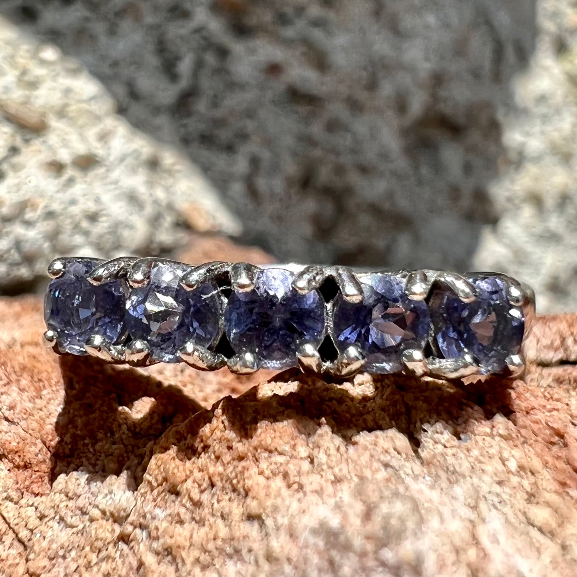 A sterling silver stackable ring set with five Standard Round Brilliant Cut tanzanite stones.