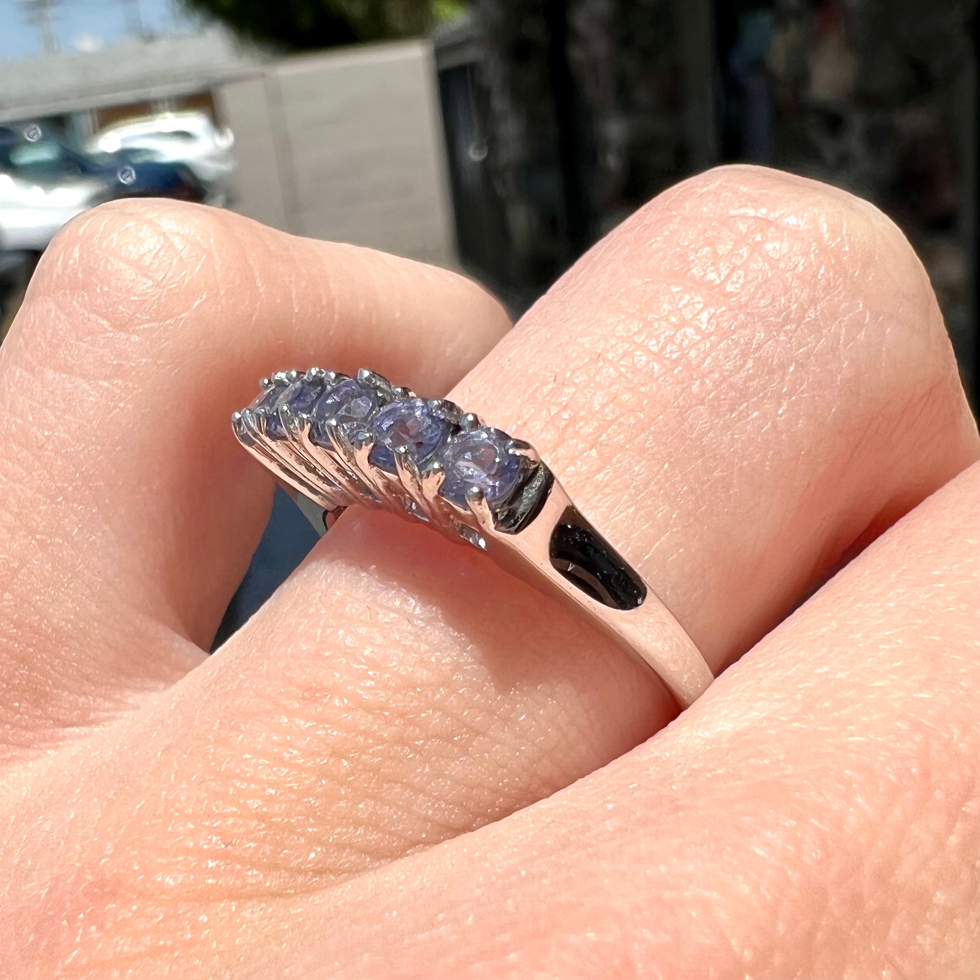 A sterling silver stackable ring set with five Standard Round Brilliant Cut tanzanite stones.