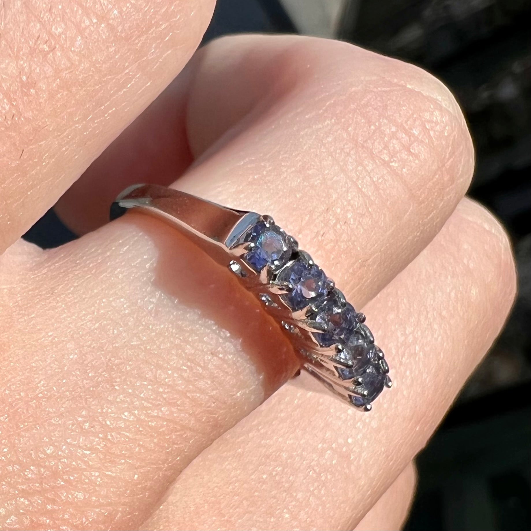 A sterling silver stackable ring set with five Standard Round Brilliant Cut tanzanite stones.