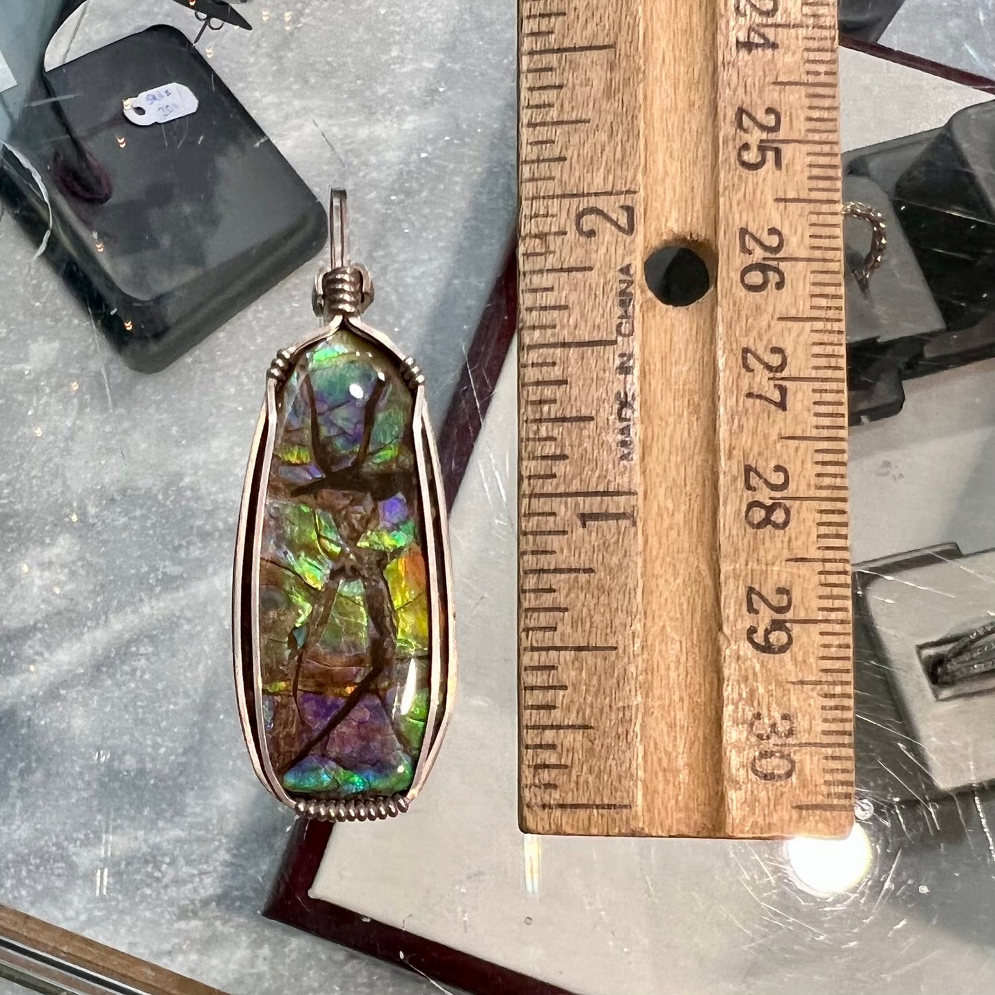 A sterling silver wire wrapped ammolite (gem quality rainbow ammonite) necklace.