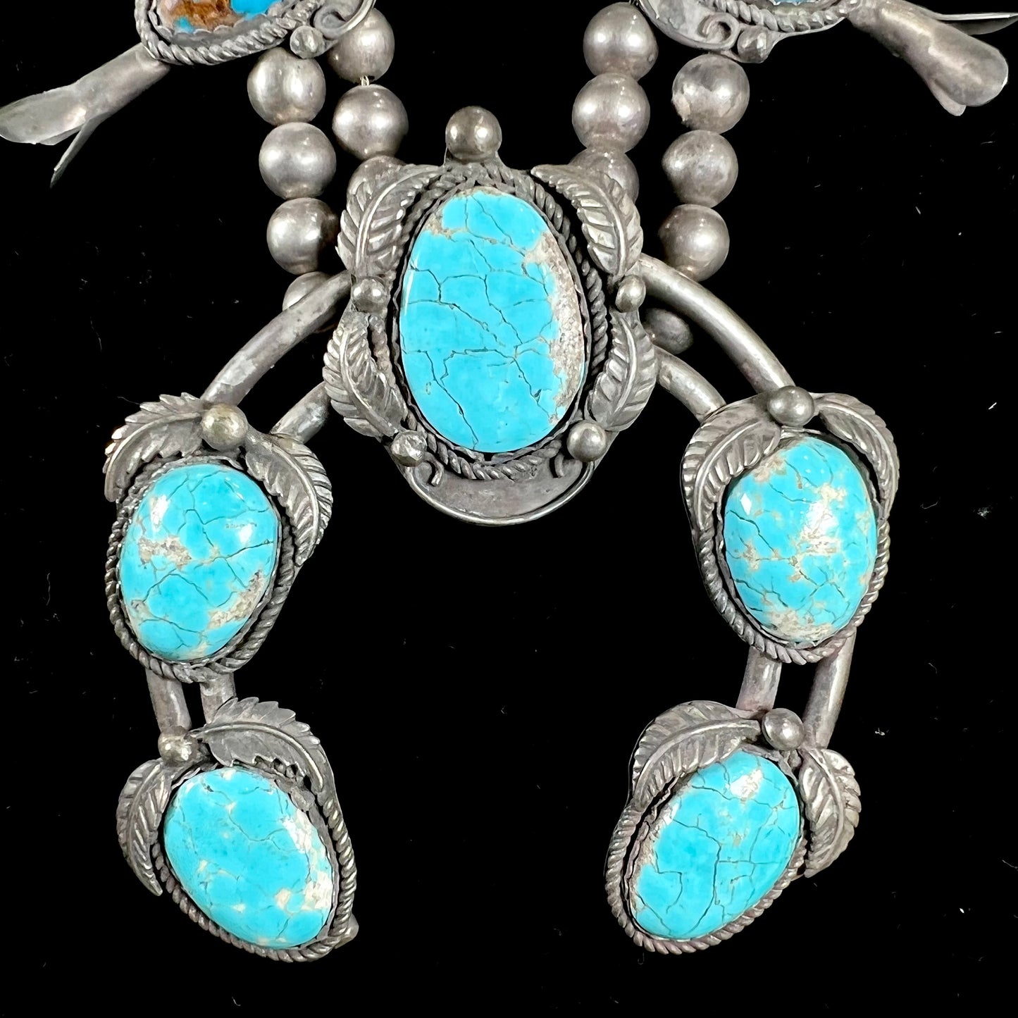 A silver Navajo men's squash blossom necklace set with Fox turquoise and Sonora turquoise.