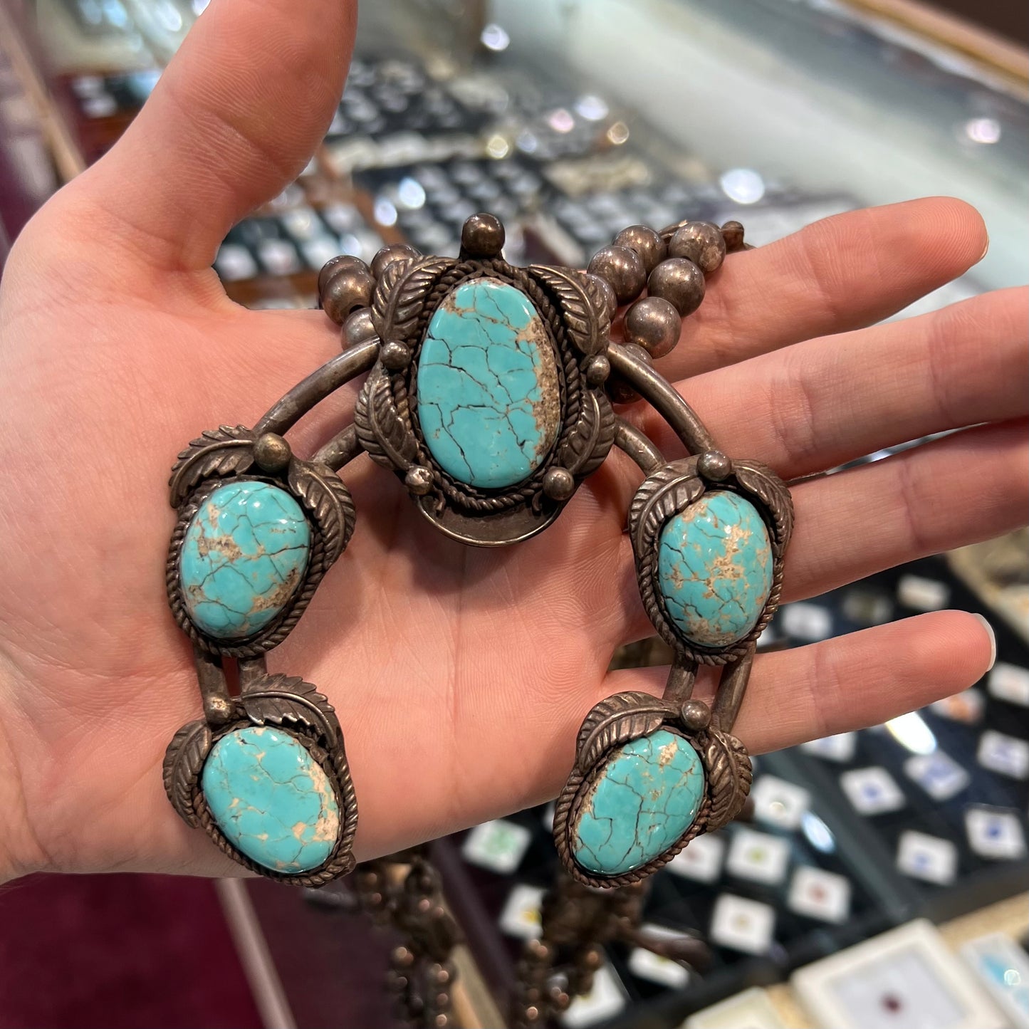 A silver Navajo men's squash blossom necklace set with Fox turquoise and Sonora turquoise.