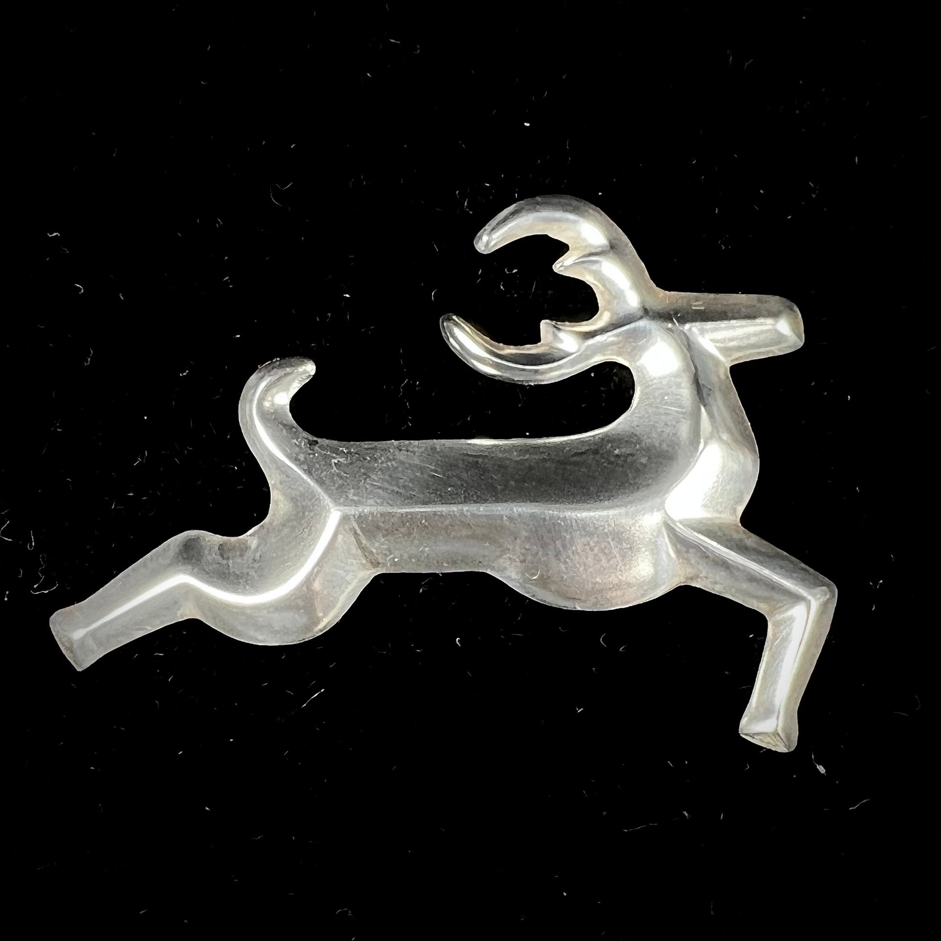 A silver brooch of a jumping deer handmade by Navajo artist Frances Jones.