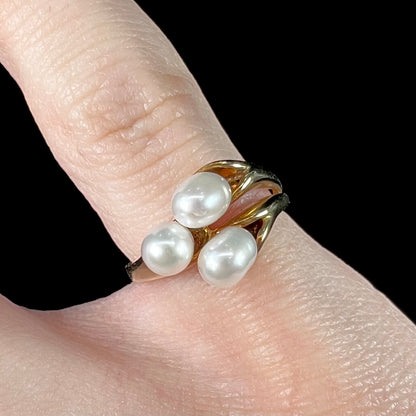 A ladies' vintage, midcentury style freshwater pearl cluster ring in yellow gold.