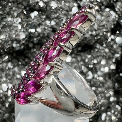 A sterling silver, feather shaped ring set with round and marquise cut rhodolite garnet stones.