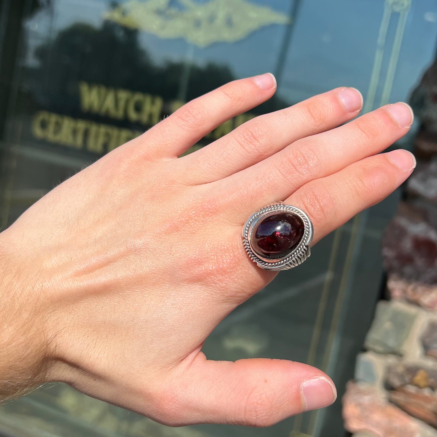 A men's sterling silver garnet ring handmade by Navajo artist Will Denetdale.