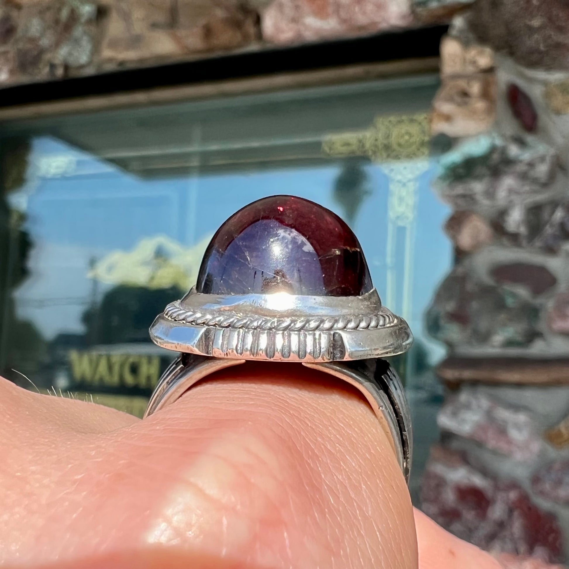 A men's sterling silver garnet ring handmade by Navajo artist Will Denetdale.