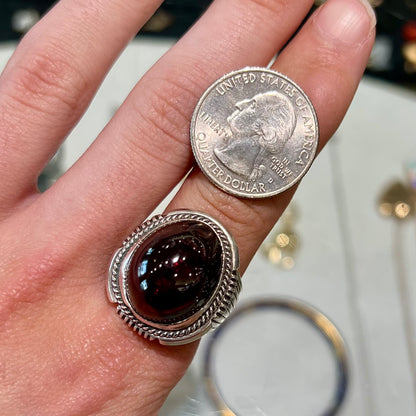 A men's sterling silver garnet ring handmade by Navajo artist Will Denetdale.