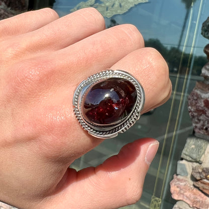 A men's sterling silver garnet ring handmade by Navajo artist Will Denetdale.