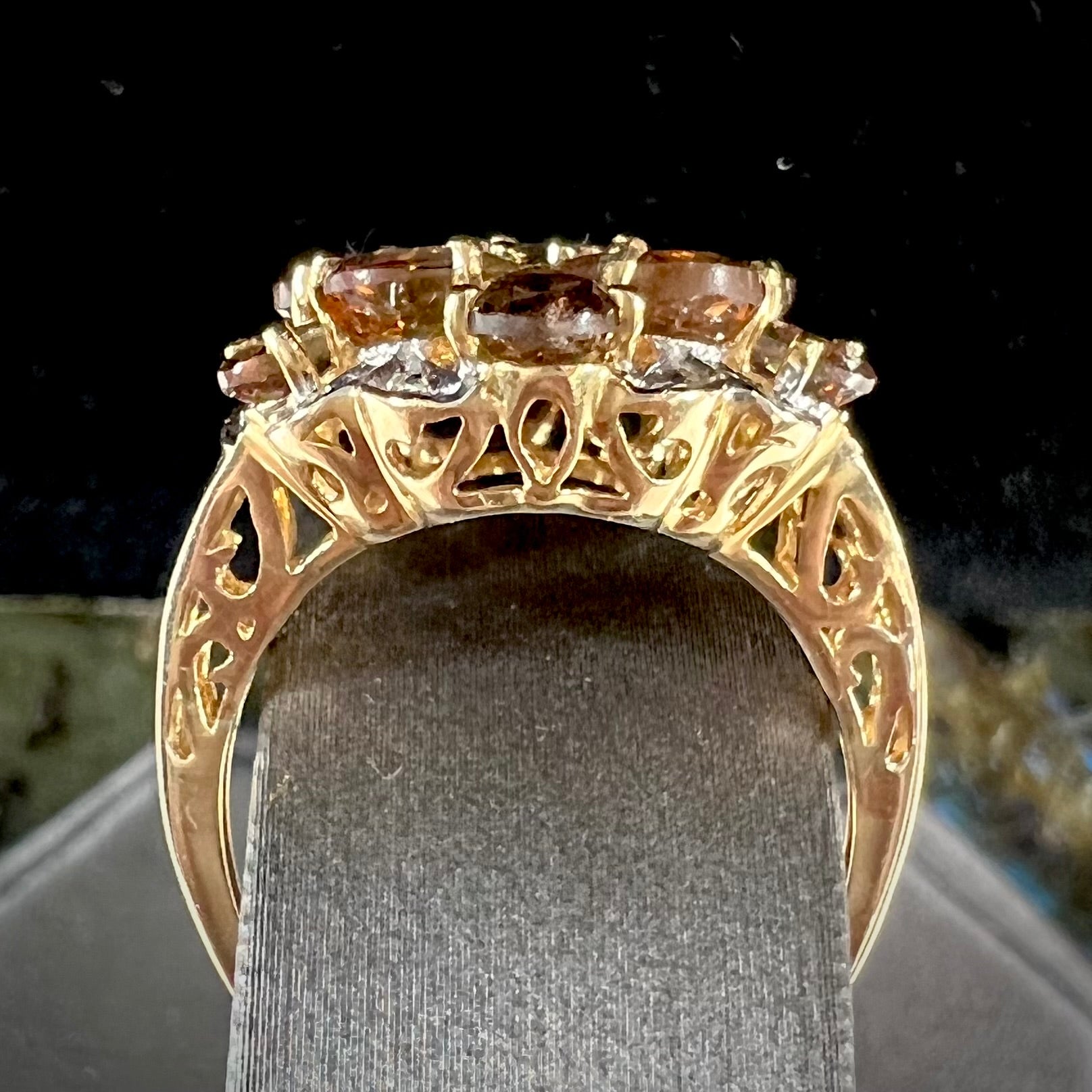 A yellow gold andalusite and diamond cluster ring.