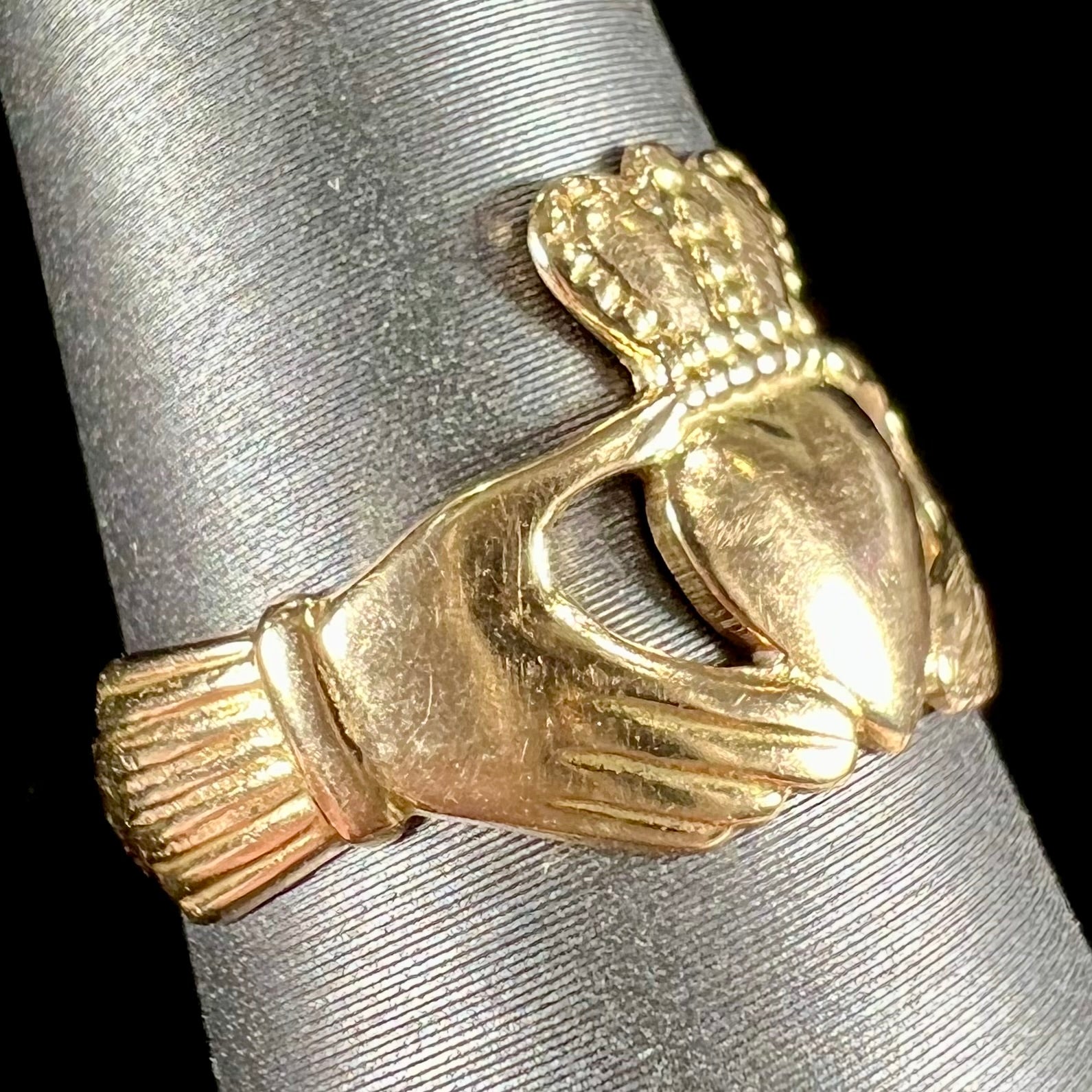 A ladies' 14 karat yellow gold Irish claddagh ring stamped with the maker's hallmarks.