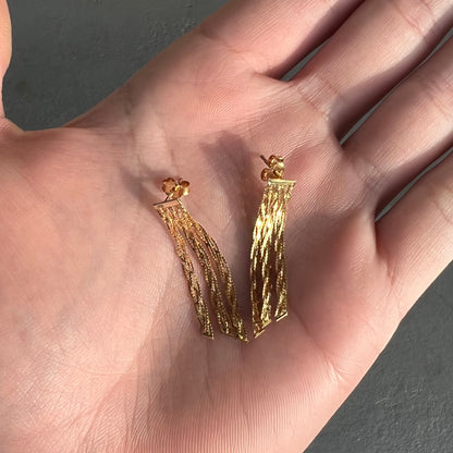 A pair of yellow gold waterfall dangle earrings.