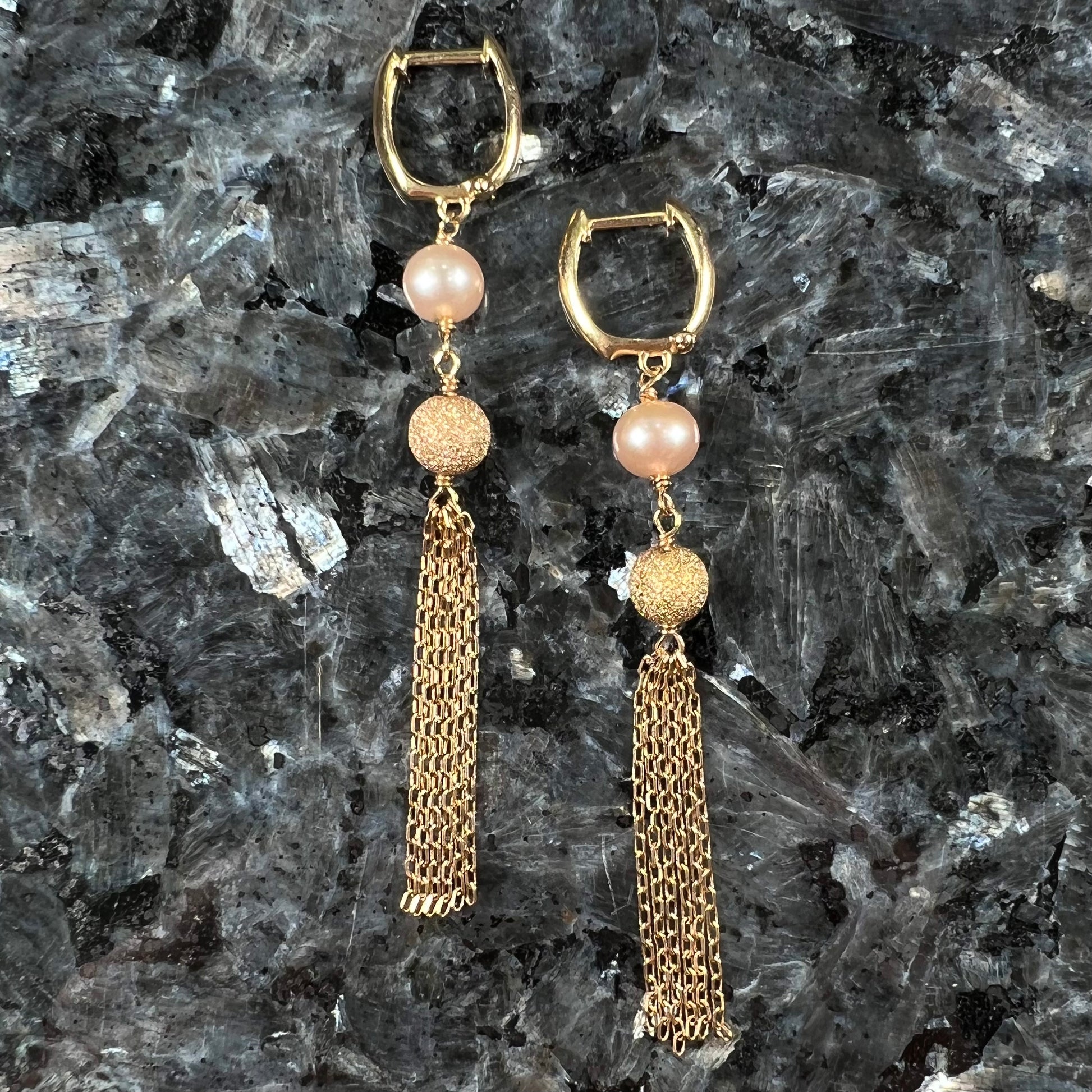 A pair of yellow gold and pink pearl dangle earrings.