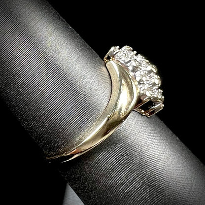 A ladies' estate yellow gold diamond cluster ring.  The diamonds are round single cuts.