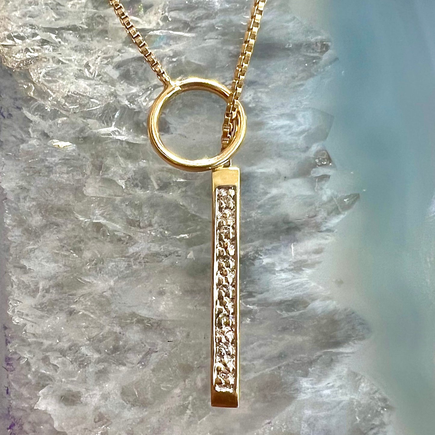 A yellow gold diamond lariat necklace on a 1mm wide box chain.  The lariat is double sided.