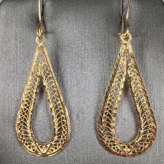 A pair of pear shape yellow gold filigree dangle earrings.