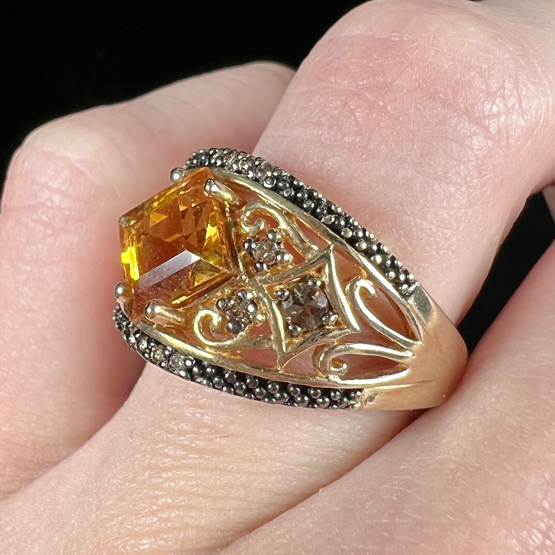 A square cut citrine and chocolate diamond filigree ring with andalusite accents.
