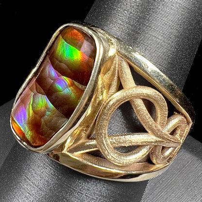 A men's yellow gold fire agate solitaire ring.  The fire agate is from Northern Mexico and has rainbow iridescence.