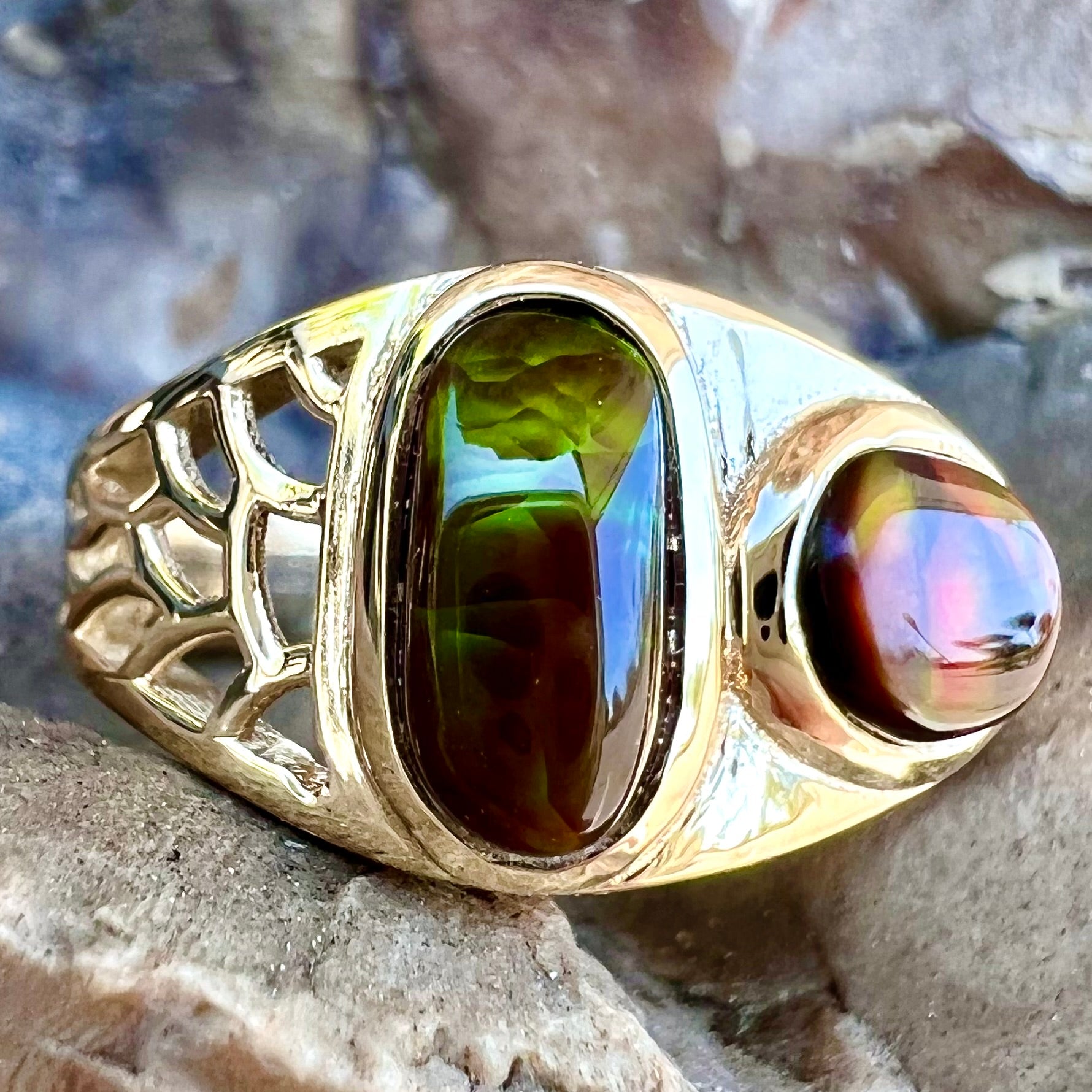 A ladies' yellow gold ring set with two fire agate stones: one green, and one red.