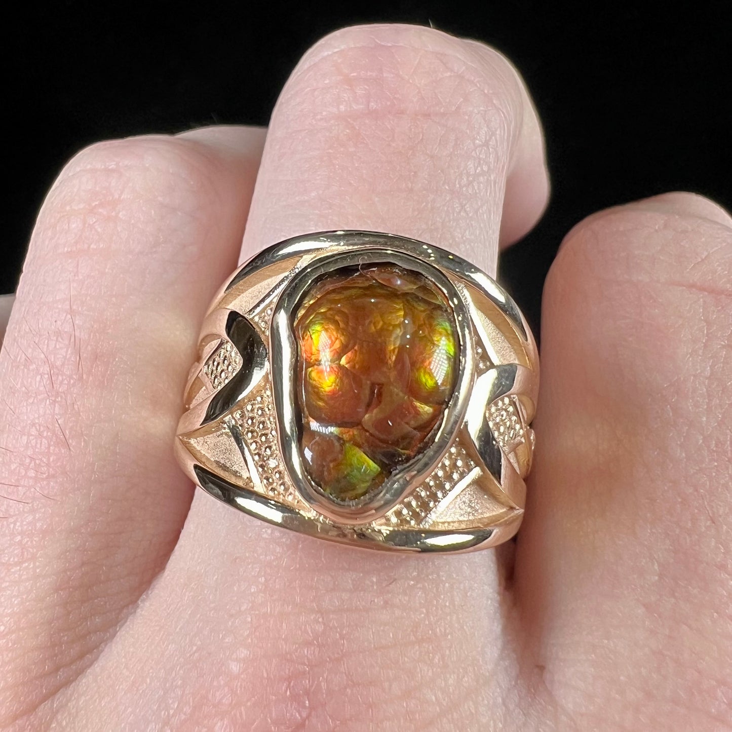 A men's 14kt yellow gold Mexican fire agate ring.