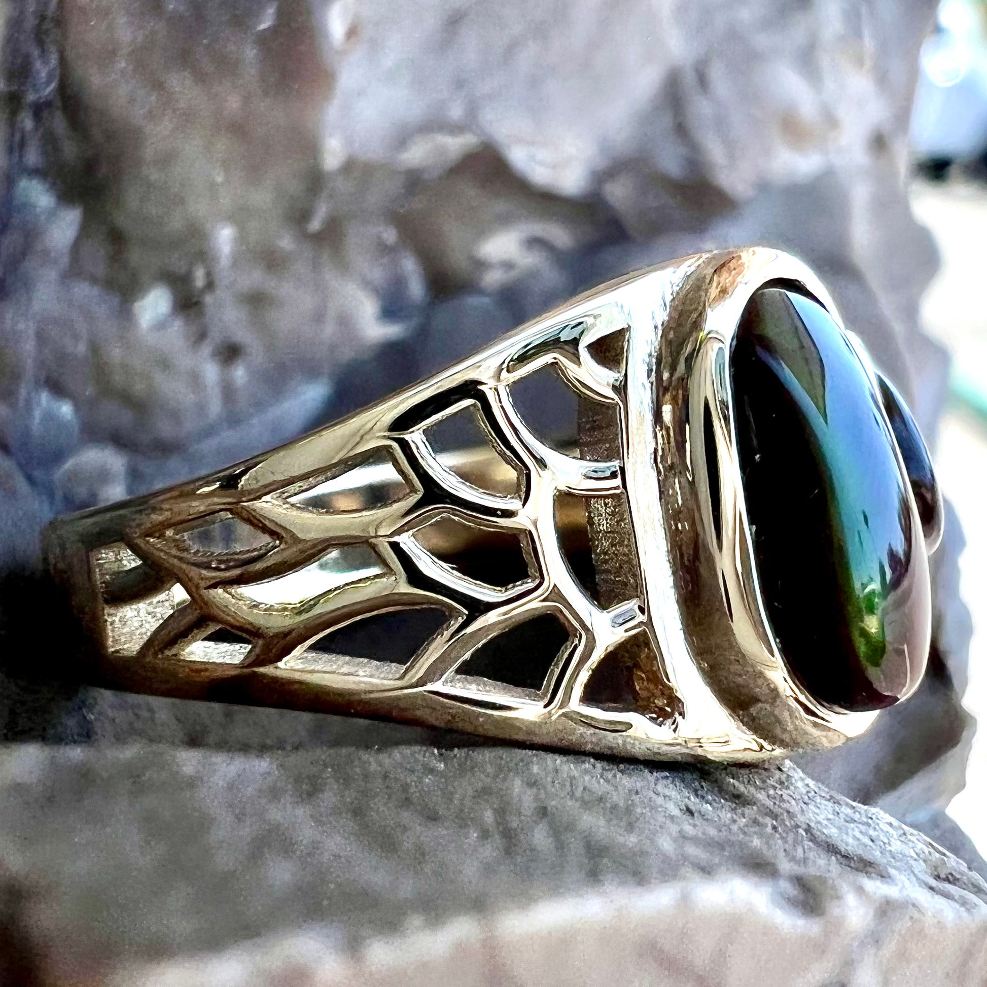 A ladies' yellow gold ring set with two fire agate stones: one green, and one red.