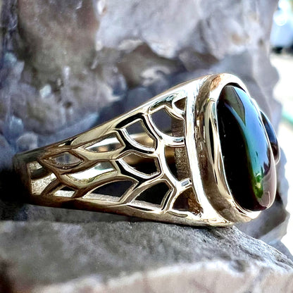 A ladies' yellow gold ring set with two fire agate stones: one green, and one red.