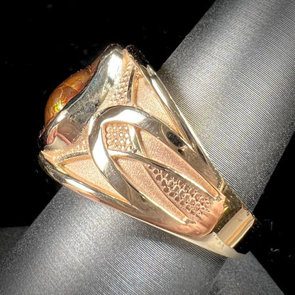 A men's 14kt yellow gold Mexican fire agate ring.