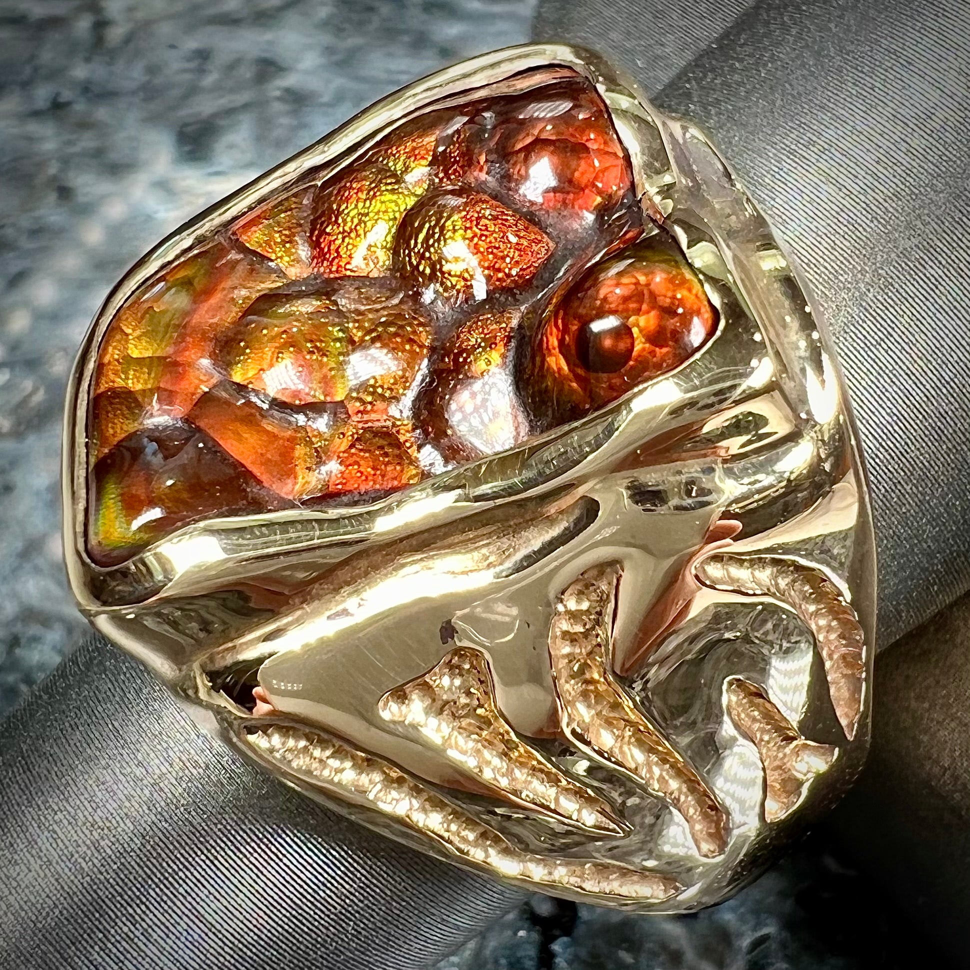 A men's custom fire agate solitaire ring cast in yellow gold.