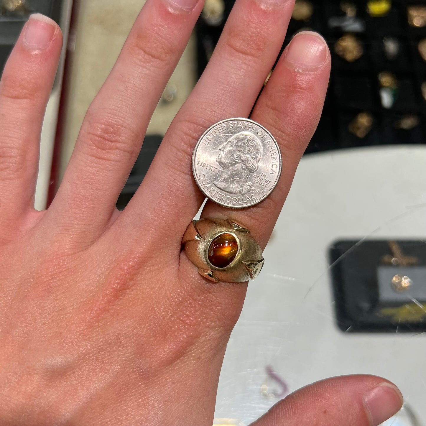 A men's brushed yellow gold fire agate ring with polished accents.