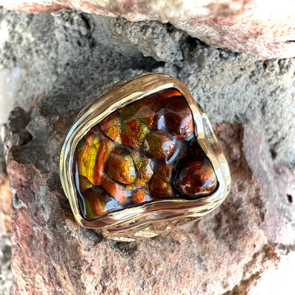 A men's custom fire agate solitaire ring cast in yellow gold.