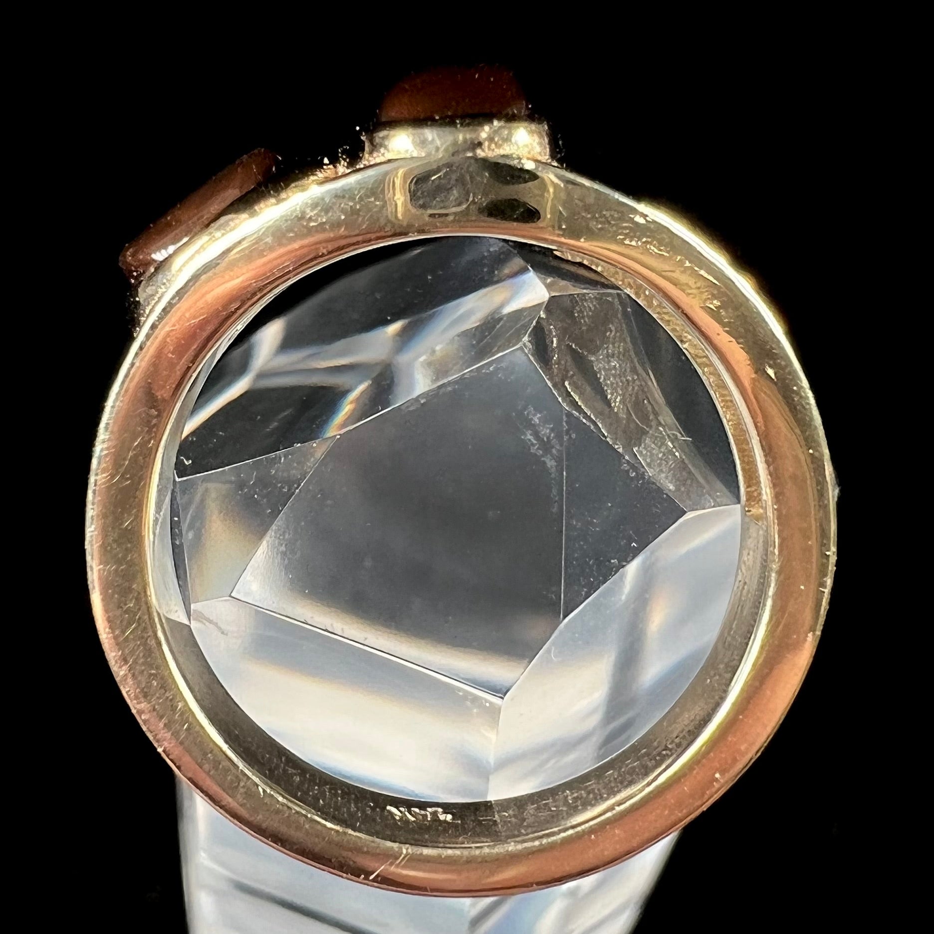 A ladies' yellow gold ring set with two fire agate stones: one green, and one red.