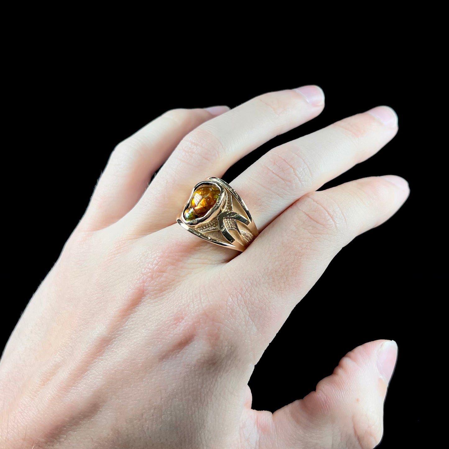 A men's 14kt yellow gold Mexican fire agate ring.