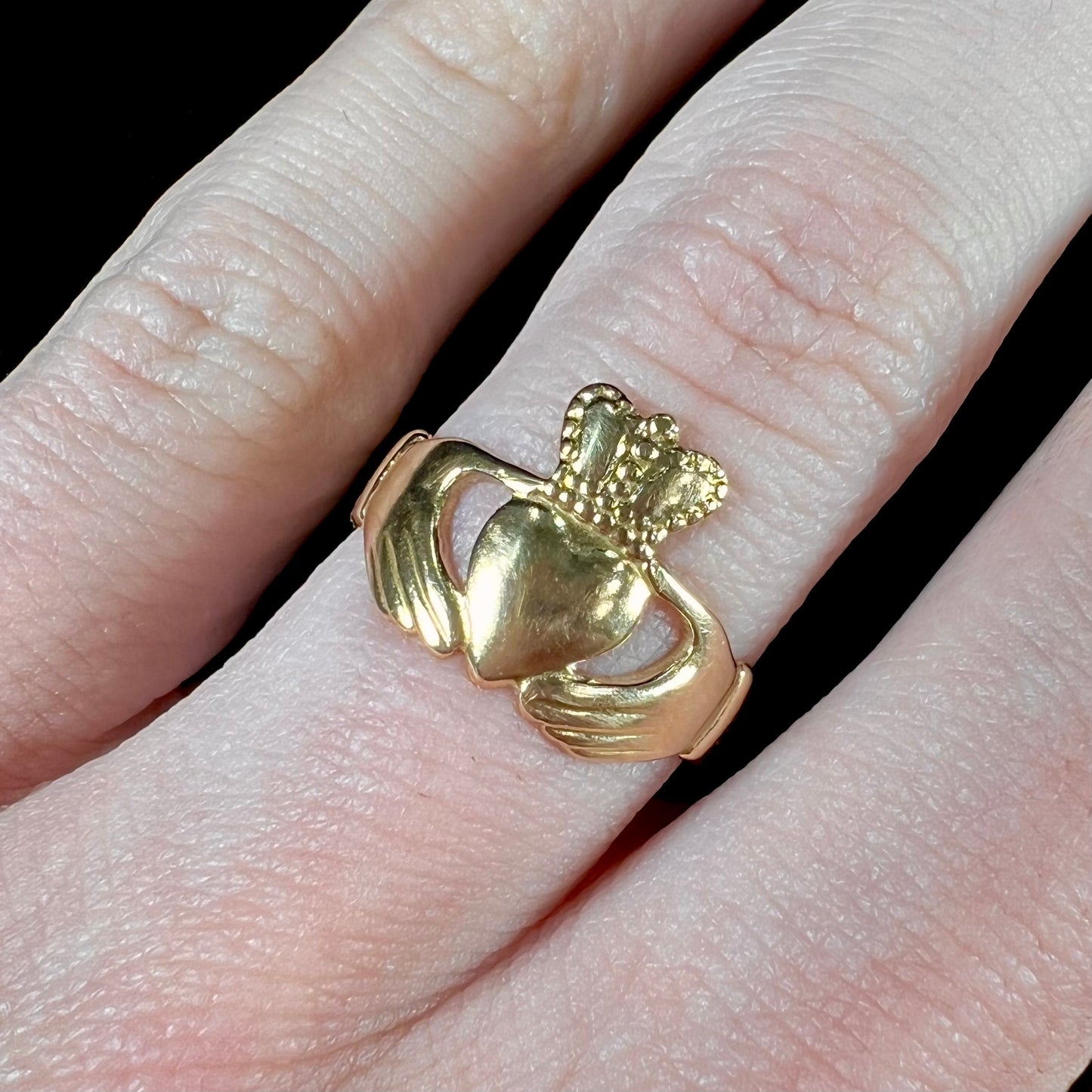 A ladies' 14 karat yellow gold Irish claddagh ring stamped with the maker's hallmarks.