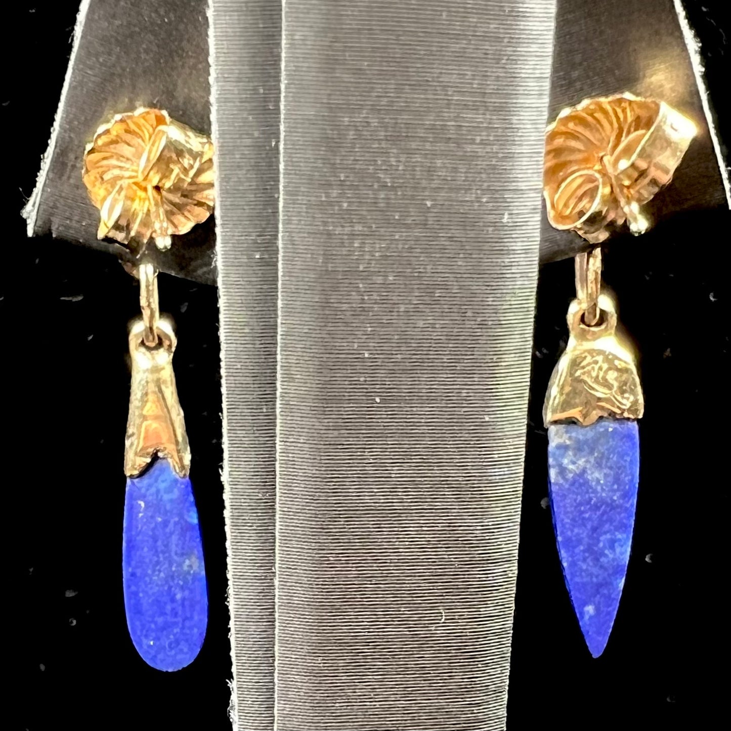 A pair of Navajo-handmade yellow gold dangle earrings set with lapis lazuli and polished coral branches.