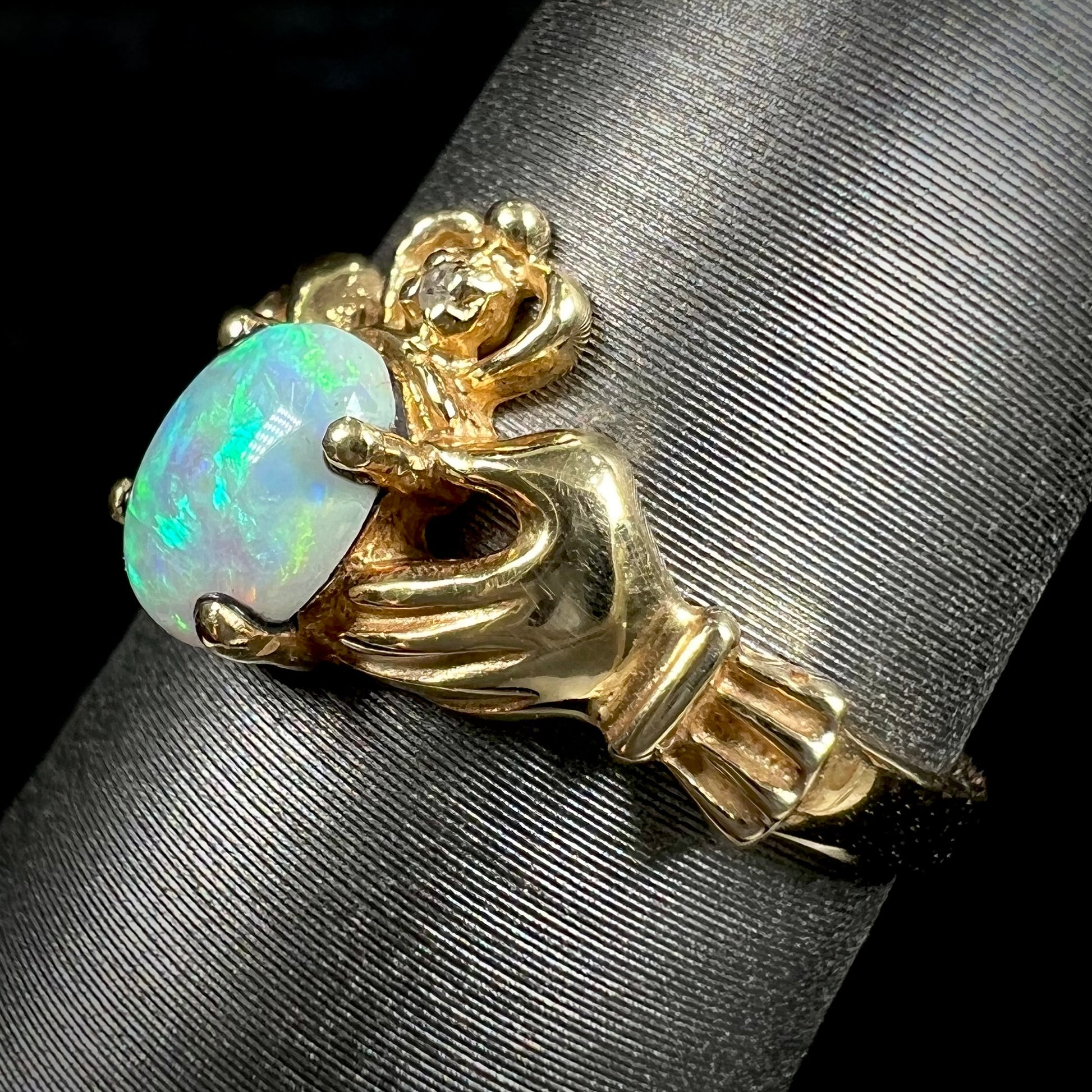 A vintage ladies' yellow gold opal and diamond claddagh ring.