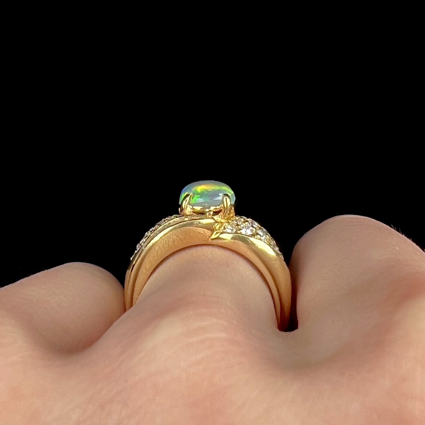 A natural, Australian black opal and diamond ring cast in 18 karat yellow gold..