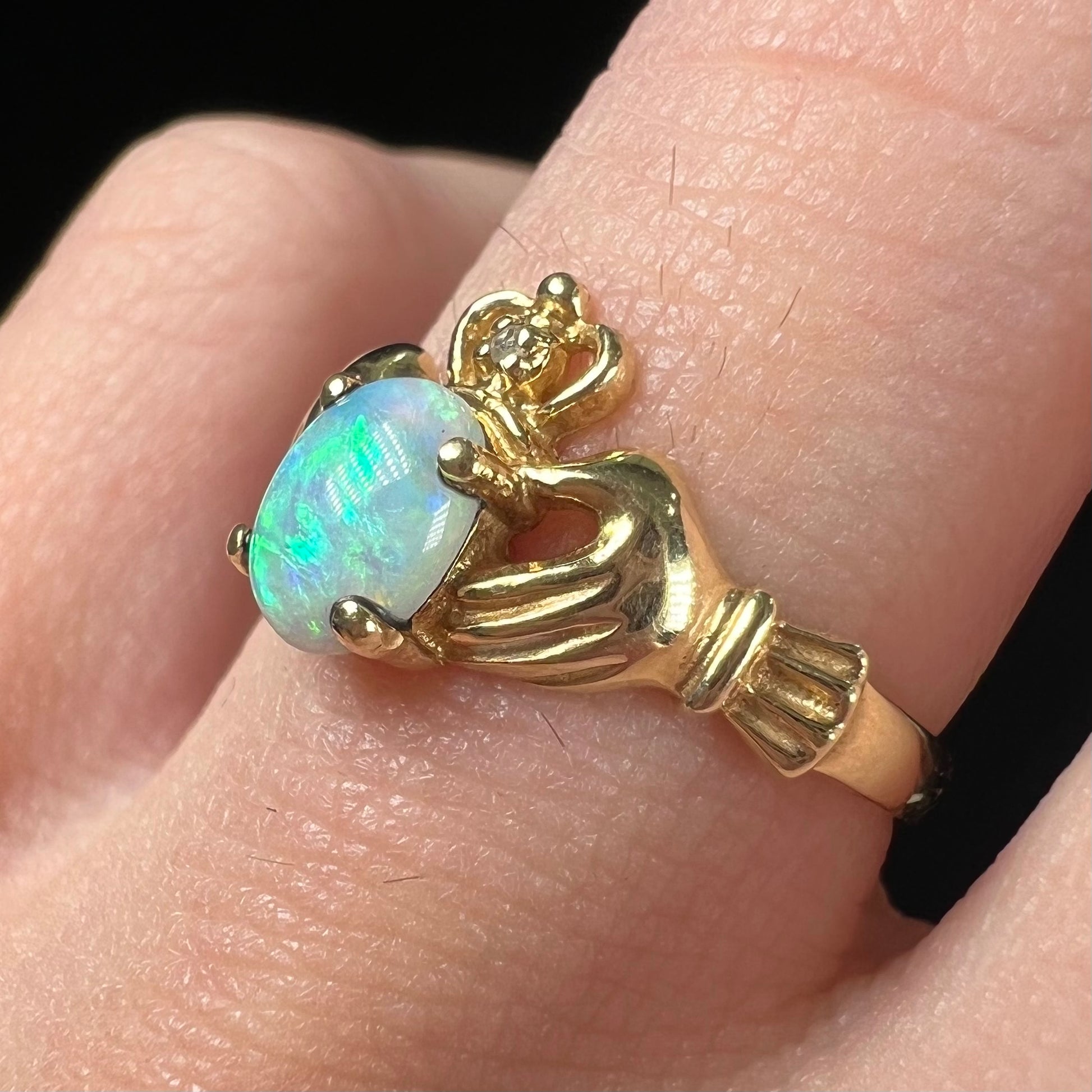 A vintage ladies' yellow gold opal and diamond claddagh ring.