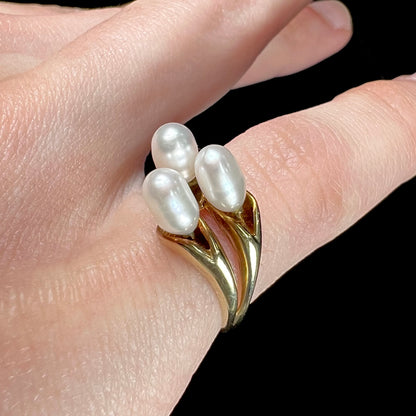 A ladies' vintage, midcentury style freshwater pearl cluster ring in yellow gold.