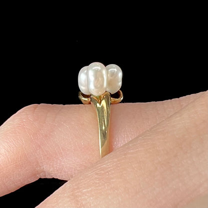 A ladies' vintage, midcentury style freshwater pearl cluster ring in yellow gold.