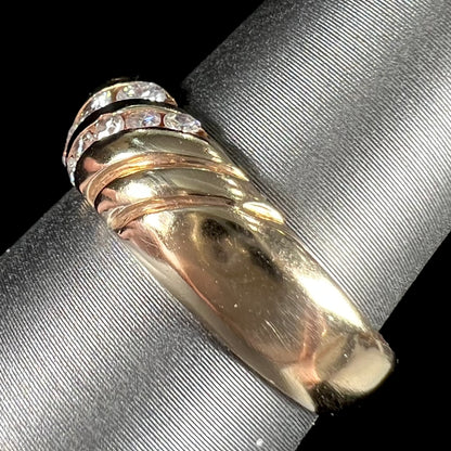 A ladies' channel set gold diamond ring.