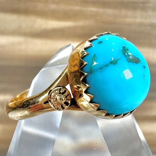 A ladies' yellow gold turquoise ring.  The turquoise is a round cabochon cut.