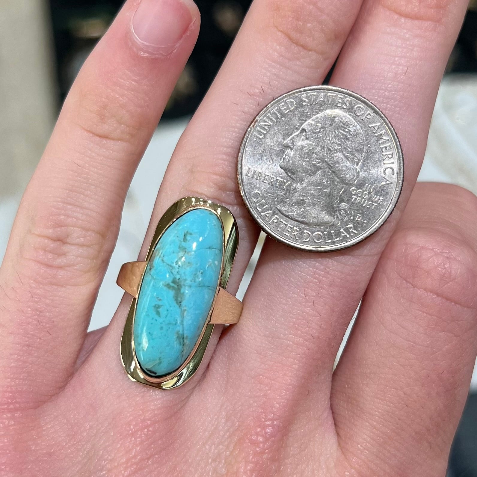 A Sleeping Beauty turquoise solitaire ring cast in 14kt yellow gold.