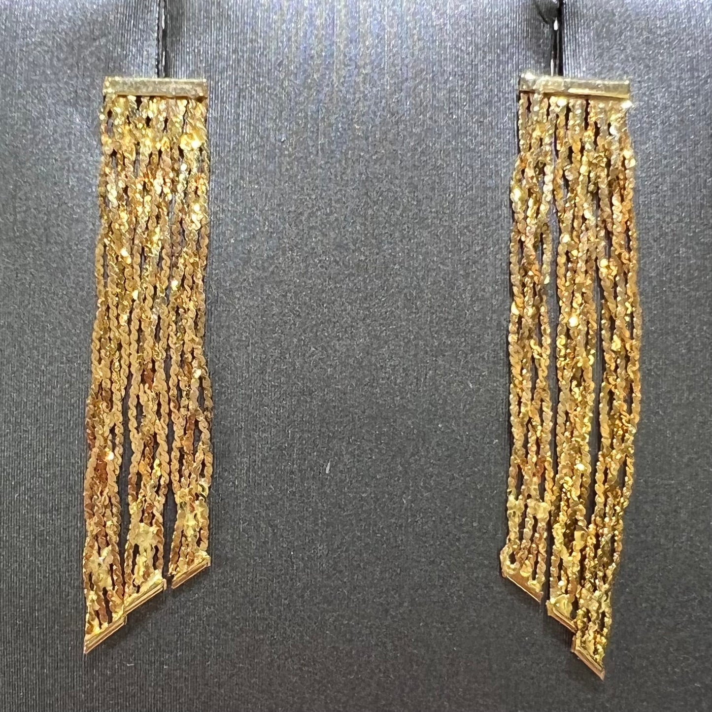 A pair of yellow gold waterfall dangle earrings.