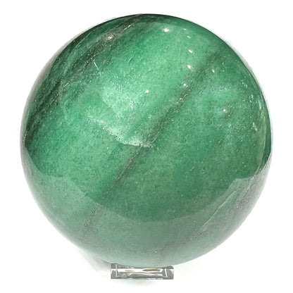 A stone sphere carved from natural green aventurine quartz with containing mica inclusions.