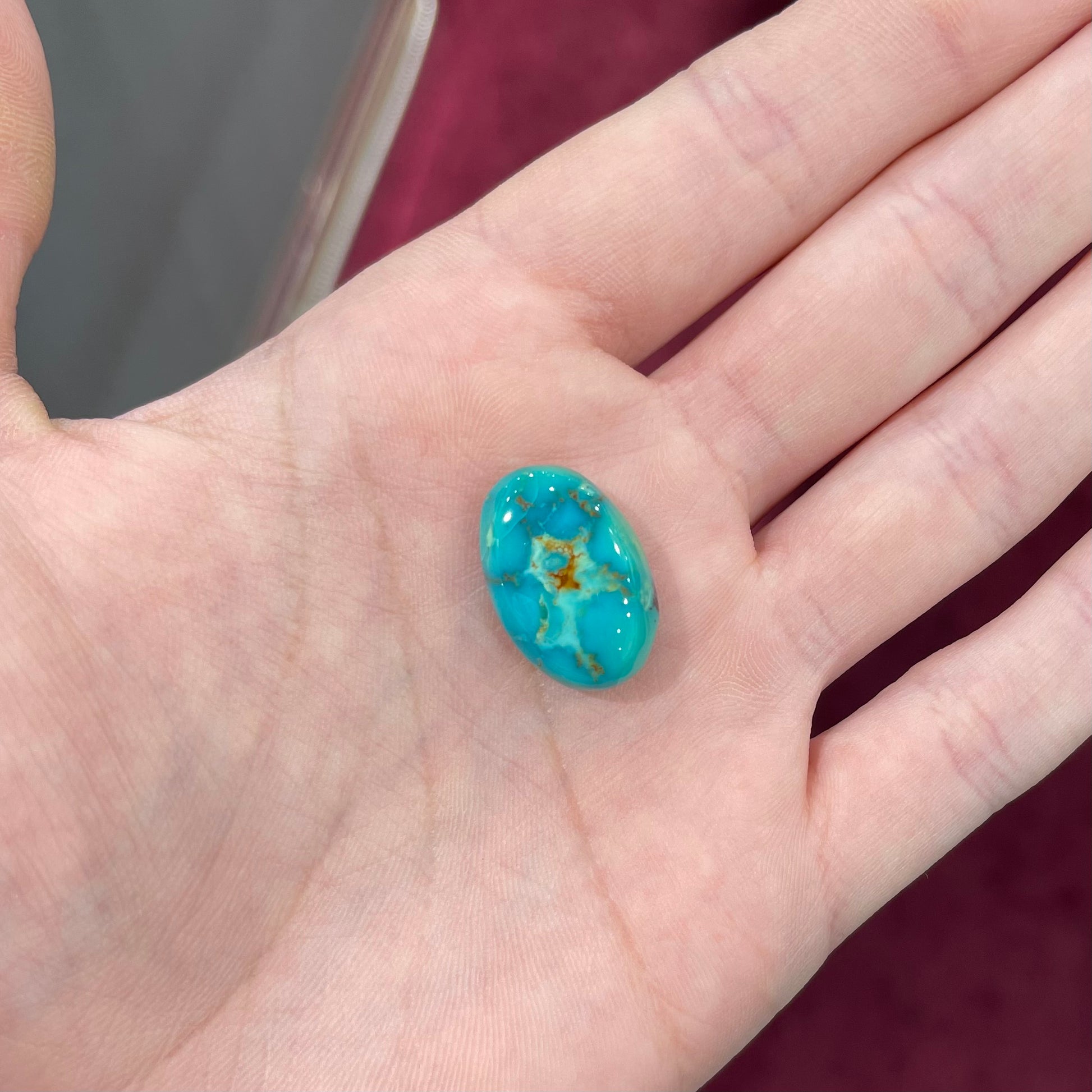 Loose Pilot Mountain turquoise with a pattern of brown matrix spots that resembles a star.  星绿松石