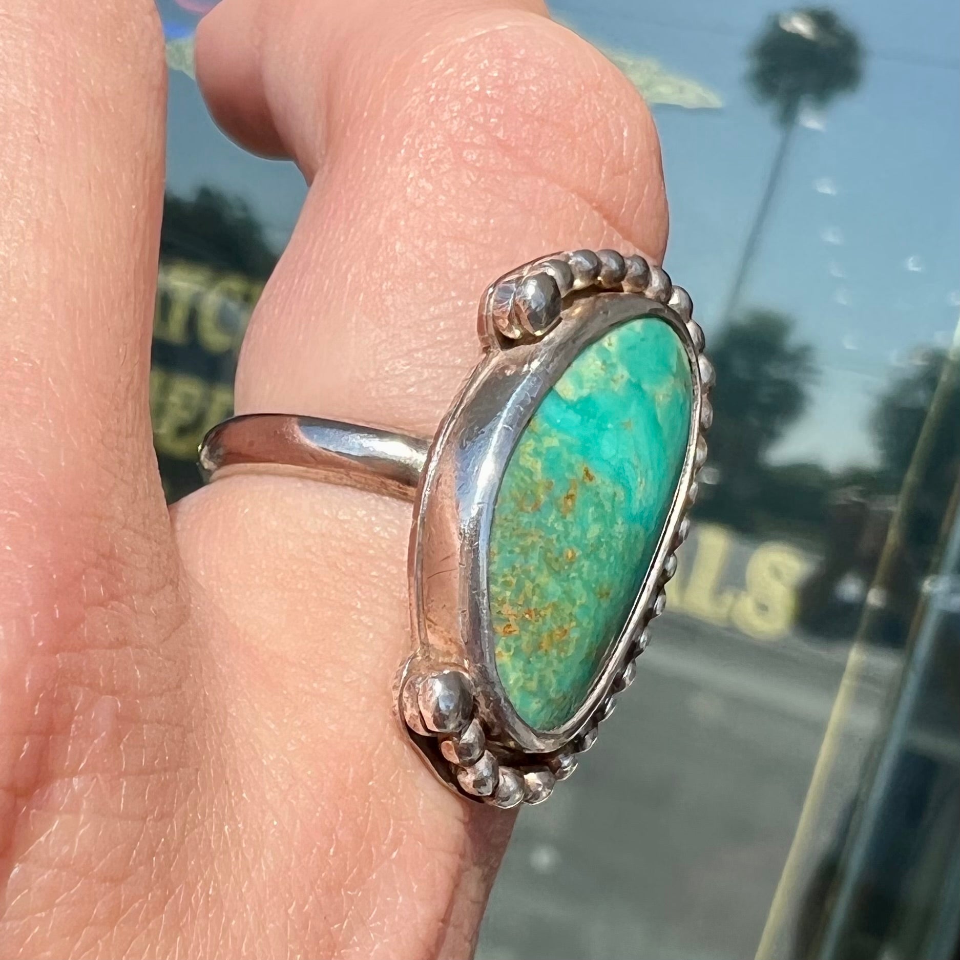 A sterling silver, Native American style green turquoise ring.  The turquoise is from the Royston Mining District.