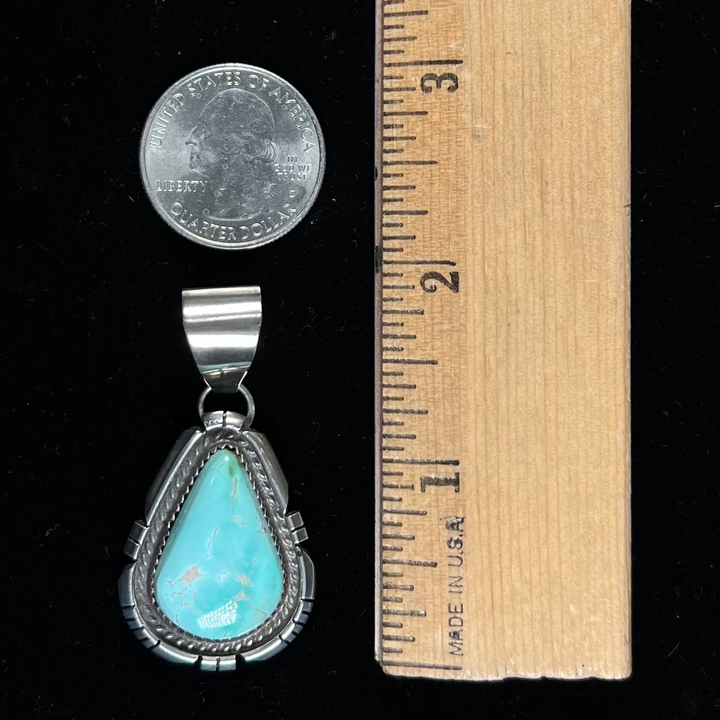 A sterling silver bezel set variscite stone pendant handmade by Navajo artist, Herman Lee.