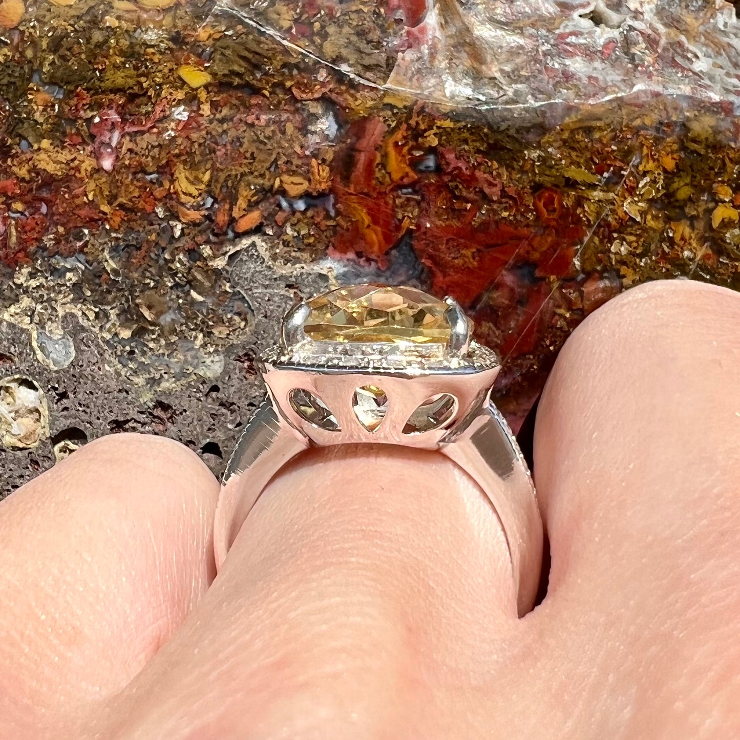 A silver cushion cut citrine and diamond halo ladies' ring.